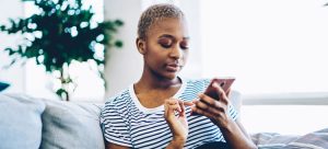 A woman using social media on her phone.