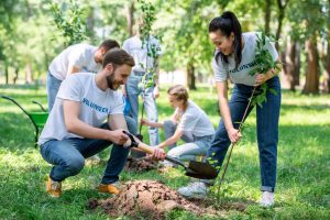 Corporate volunteers planting trees on their day off using volunteer time off.